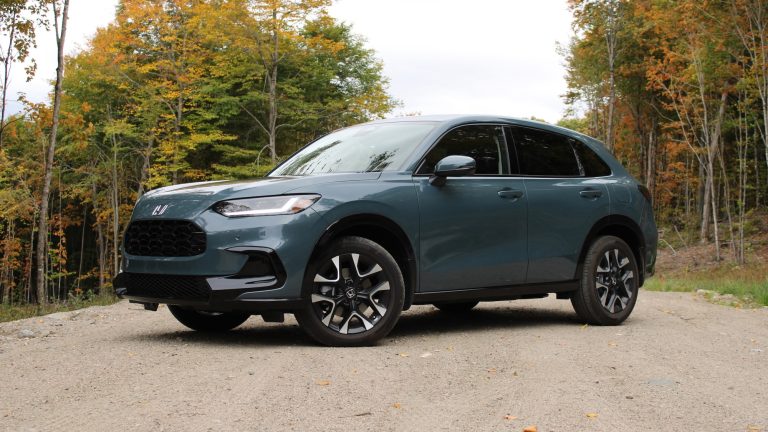 Honda HR-V EX-L parked beside an autumn forest, showcasing its modern compact SUV design