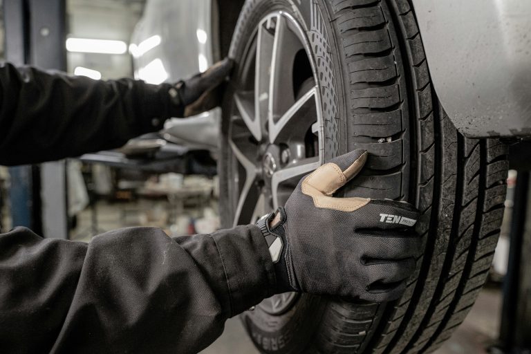 A mechanic is trying to repair his car's wheel