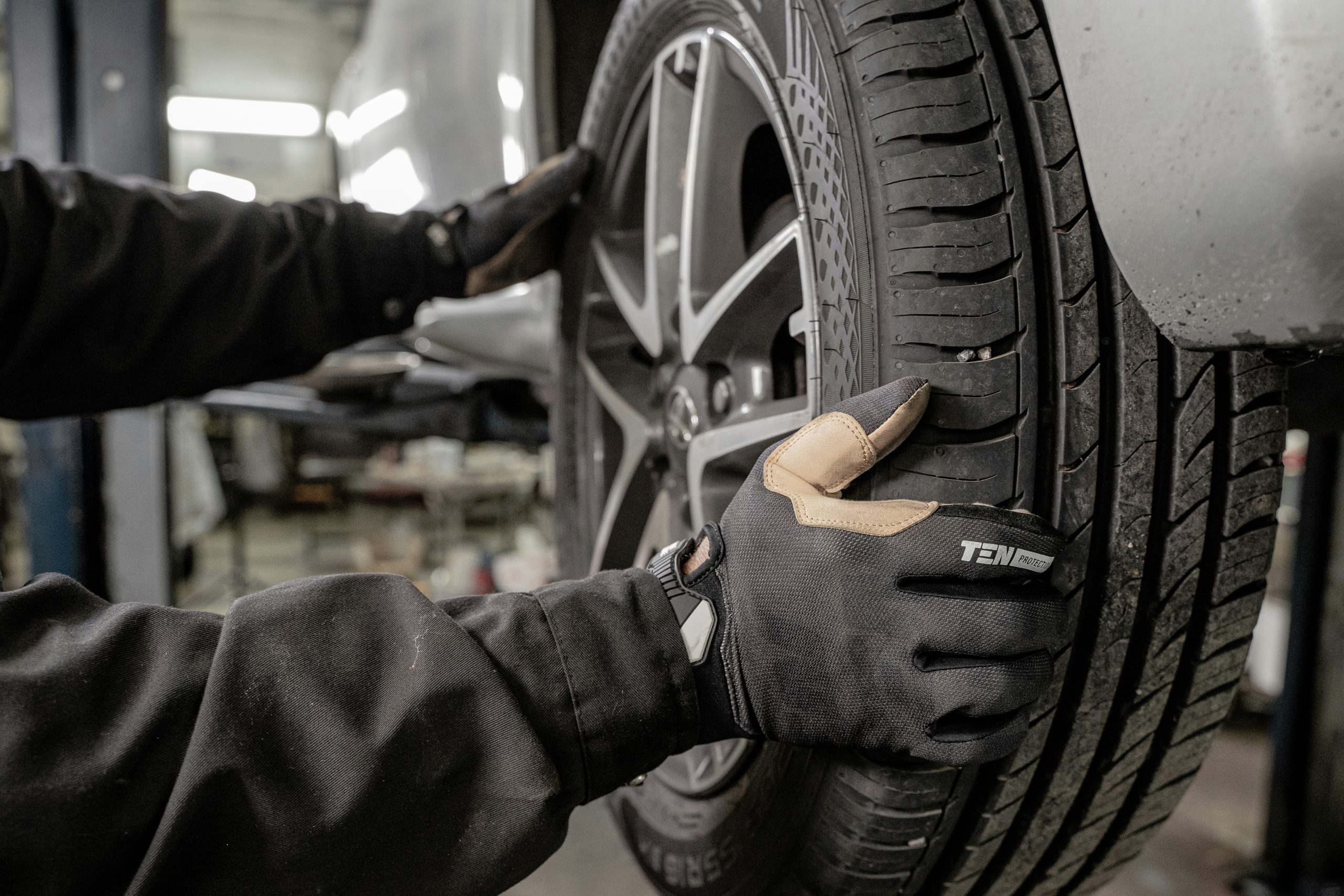 A mechanic is trying to repair his car's wheel
