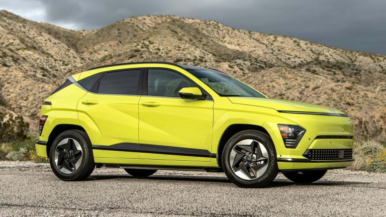 Hyundai Kona parked on a rugged mountain road with dramatic hills rising behind