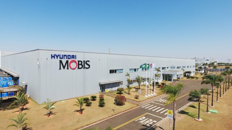 Hyundai Mobis manufacturing facility surrounded by landscaped grounds and palm-lined roads
