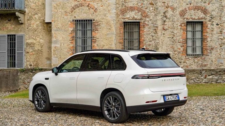 Leapmotor B10 parked outside a historic stone building, showcasing its sleek rear design and modern styling