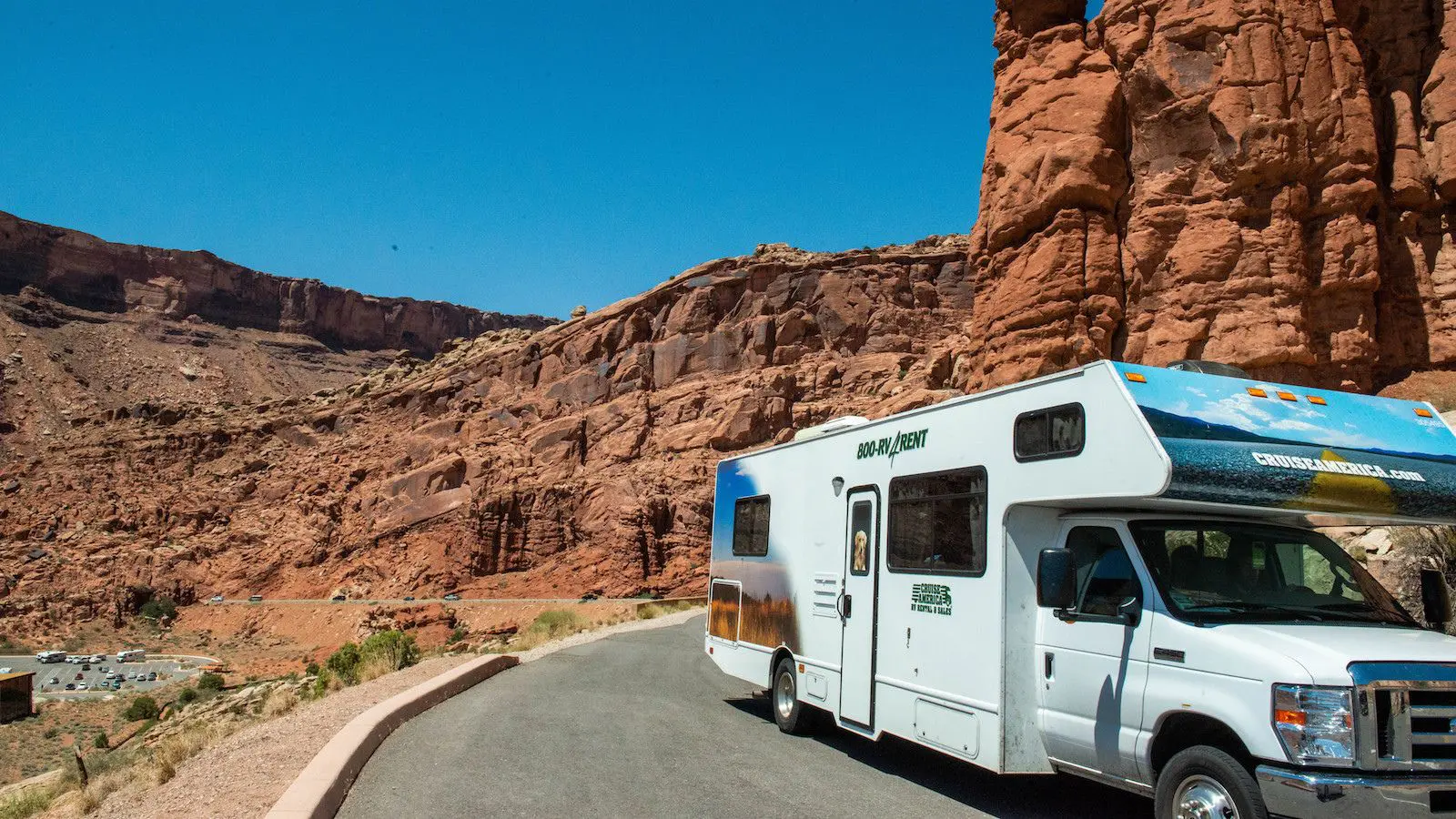 One RV is cruising in a hilly road on a sunny day