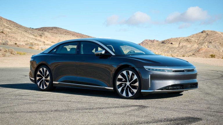 Lucid Air Grand Touring parked against a rugged desert mountain landscape