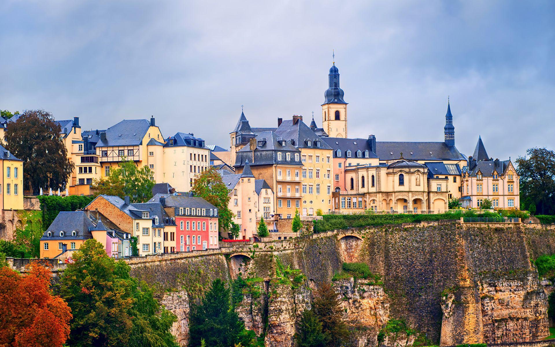 Luxembourg’s historic Old Town features colorful buildings perched above dramatic stone cliffs