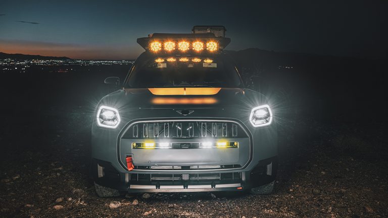 MINI Countryman Untamed Edition illuminated by powerful roof-mounted lights during a rugged nighttime adventure