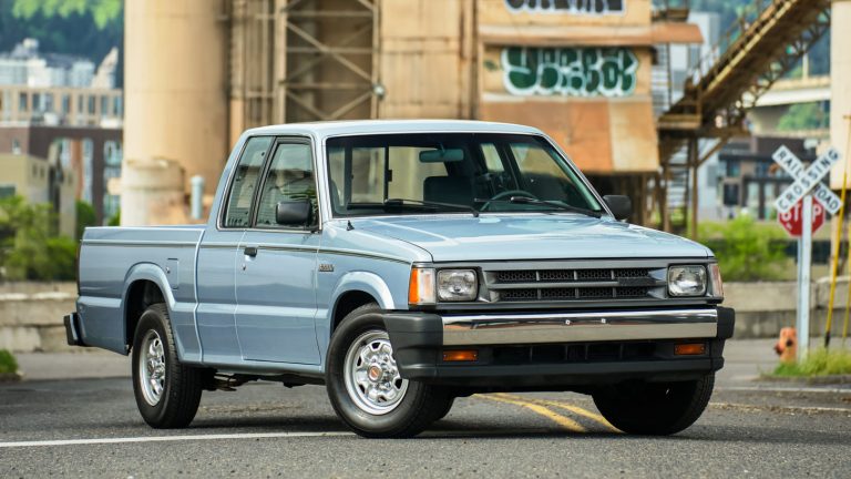 Mazda B-Series pickup parked near an industrial railway crossing, showcasing its classic compact-truck design
