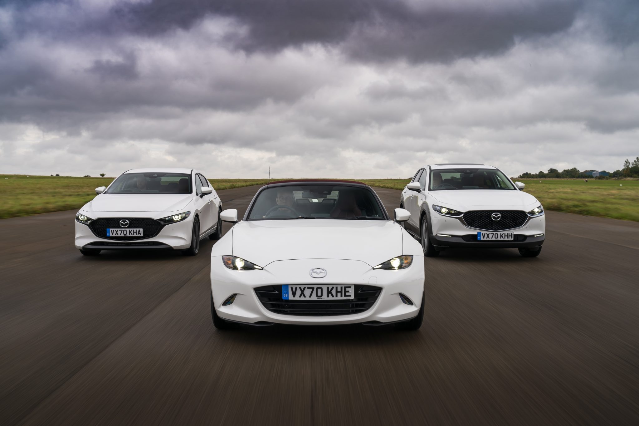 Mazda MX-5 leads two Mazda models down a scenic test track