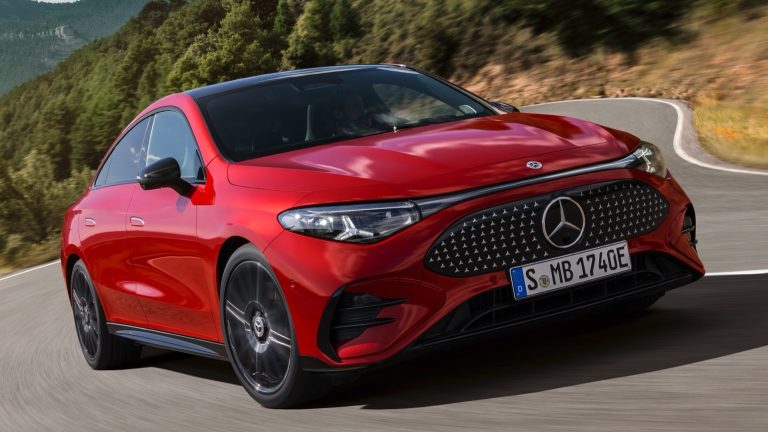 Mercedes-Benz CLA electric sedan navigating a winding mountain road, showcasing its sleek design and sporty stance