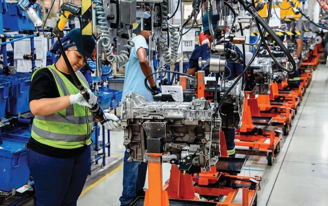 Workers assembling automotive parts on a factory production line