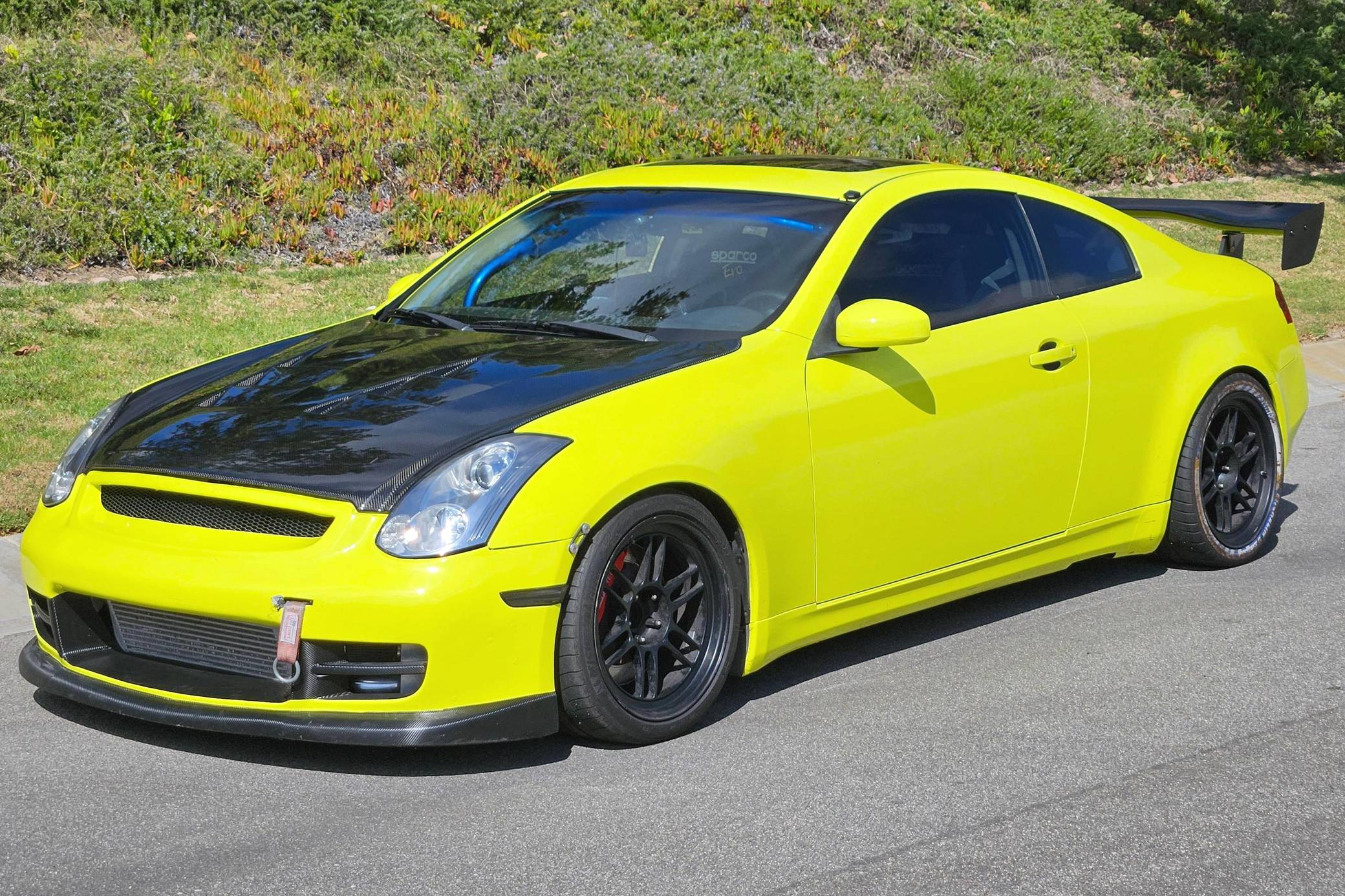 Modified Infiniti G35 coupe parked outdoors with sporty styling and performance-inspired details