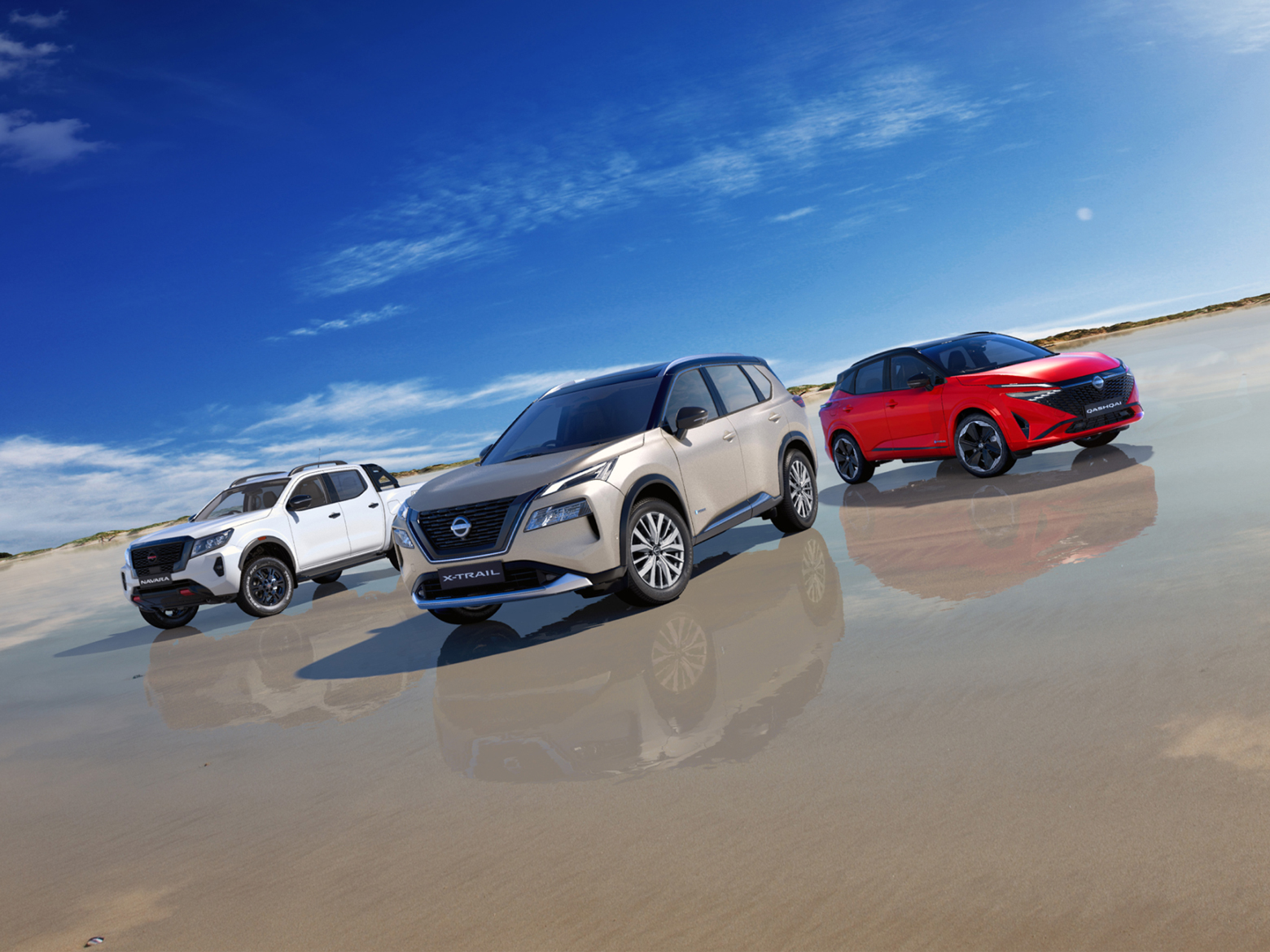 Nissan Navara, X-Trail, and Qashqai SUVs showcased together on a coastal landscape