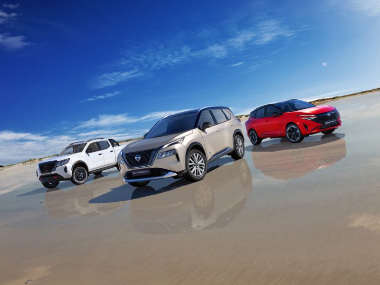Nissan Navara, X-Trail, and Qashqai SUVs showcased together on a scenic open road