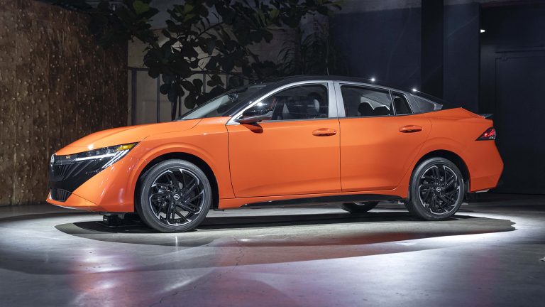 Orange Nissan Sentra displayed in a modern showroom, highlighting its sharp styling and sporty wheels