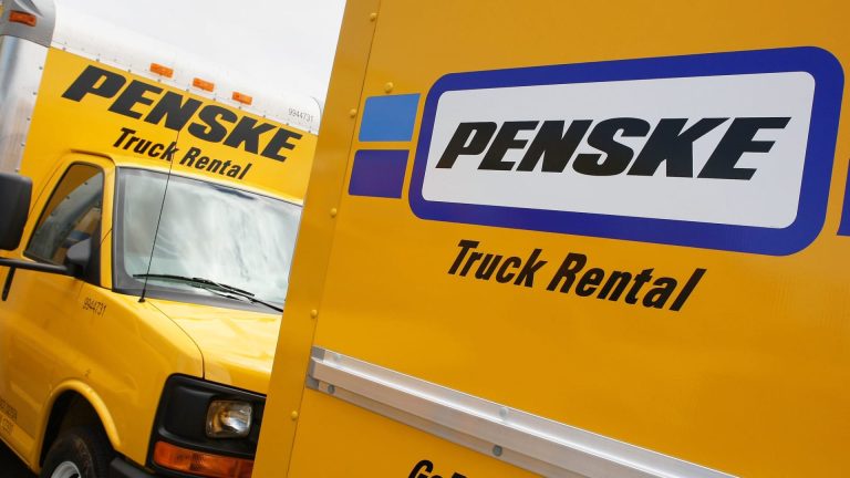 Penske Truck Rental vehicles lined up, showcasing the company’s bright yellow trucks and prominent branding