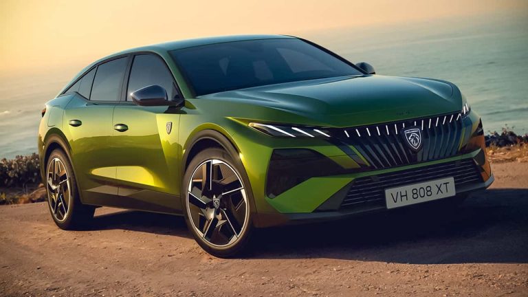 Peugeot 408 parked beside the coast at sunset, highlighting its striking fastback styling and modern design