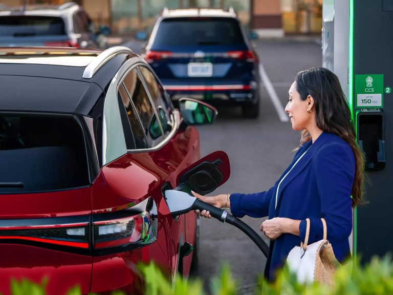 Driver charging EV at station