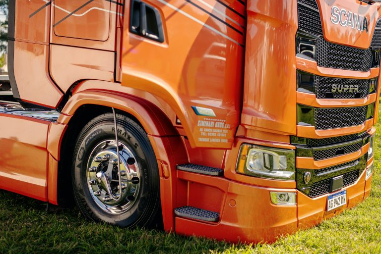 A modified truck is shown with a massive fender almost covering the tires