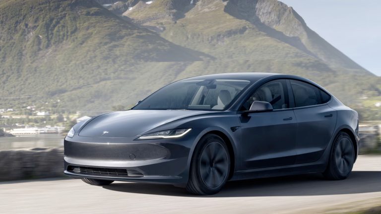 Tesla Model 3 drives along a scenic mountain road, showcasing sleek electric sedan styling