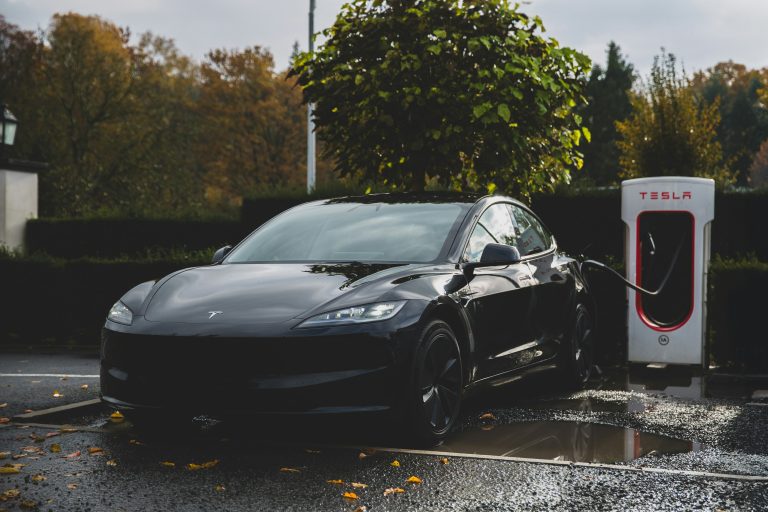 A Tesla is getting charged from an official charger