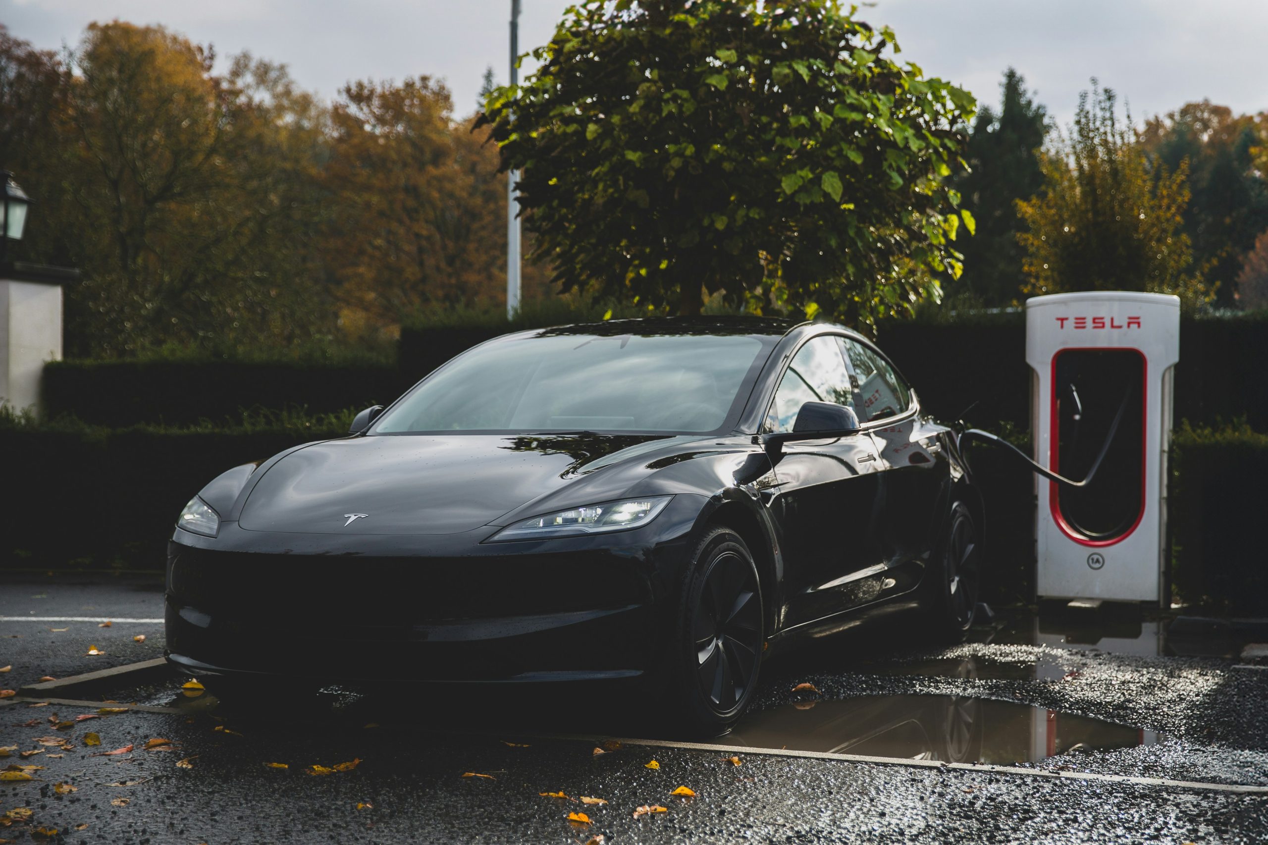 A Tesla is getting charged from an official charger