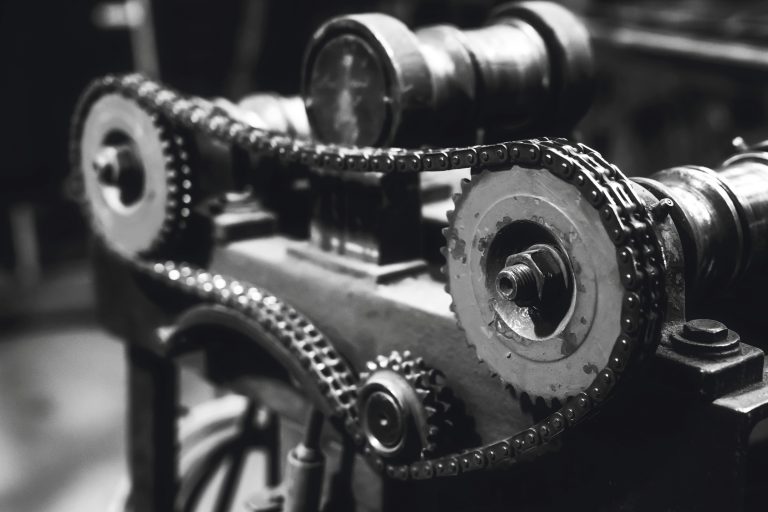 A timing belt is attached to the gears of an engine