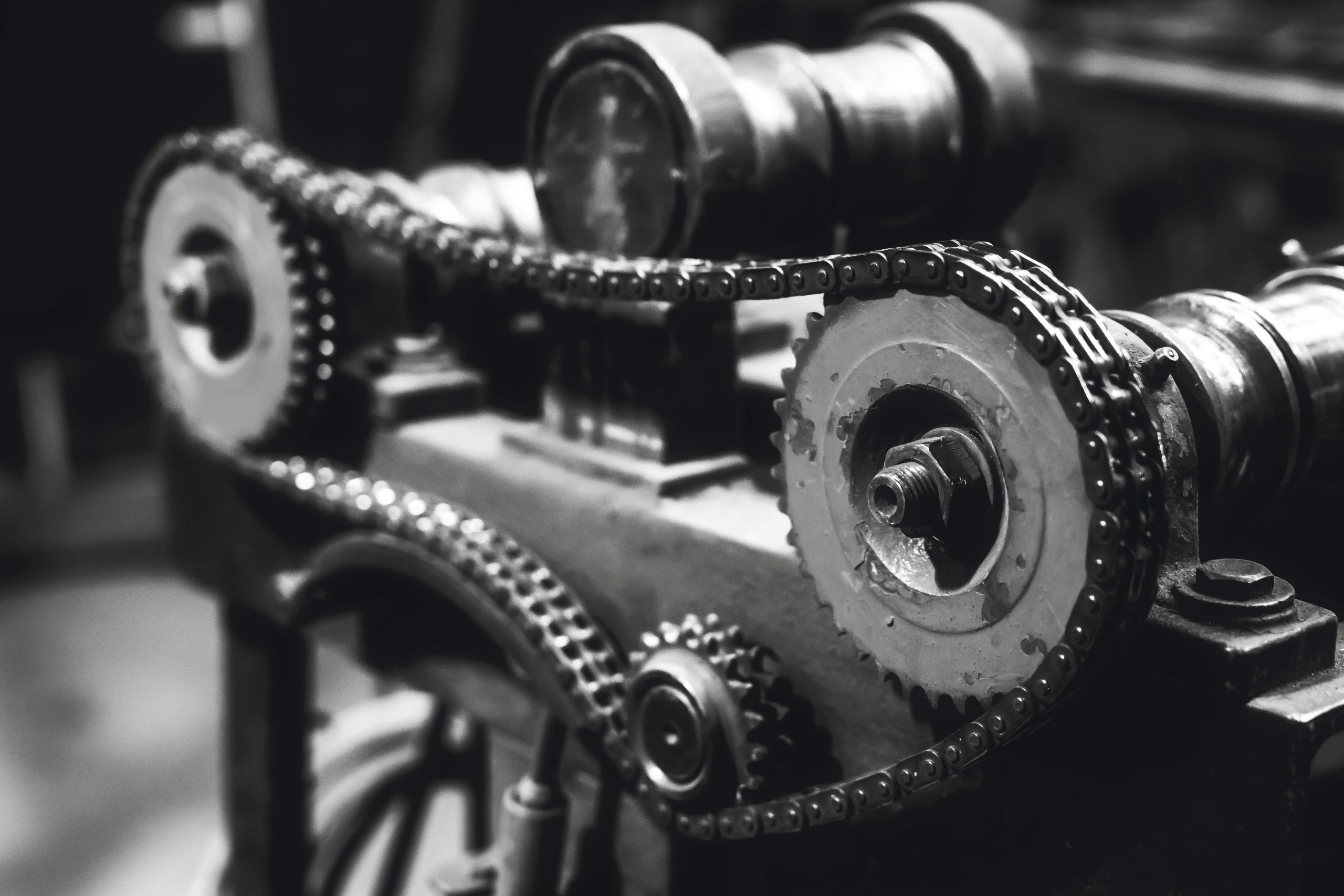 A timing belt is attached to the gears of an engine