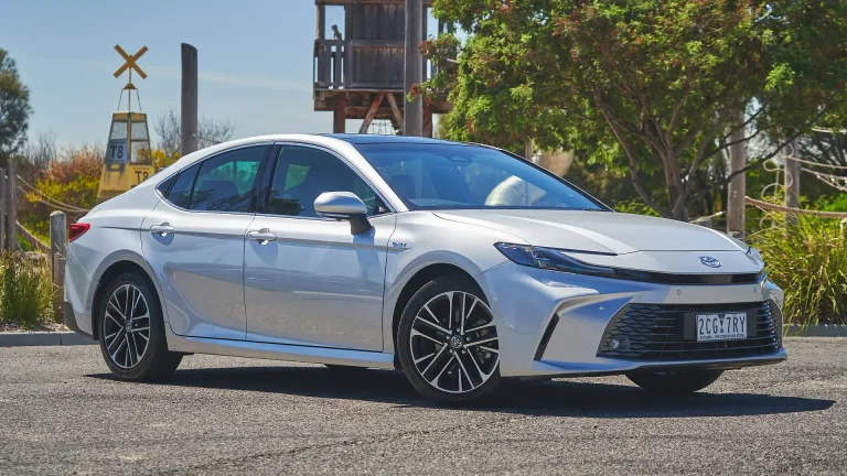 A Toyota Camry is standing on a road on a sunny day