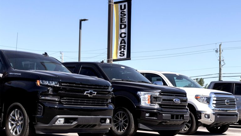 Used Chevrolet Silverado, Ford F-150, and Toyota Tundra pickup trucks displayed at a dealership