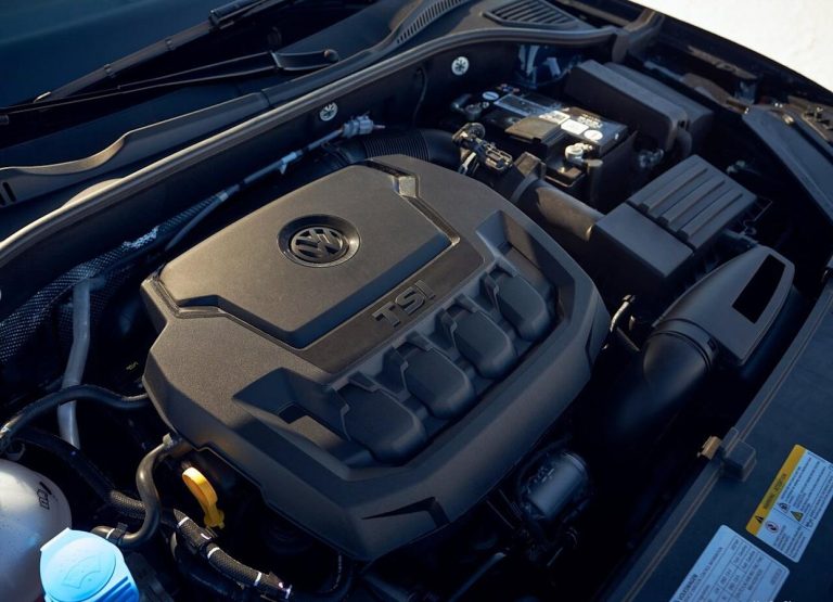 Volkswagen 2.0-liter TSI engine bay featuring the engine cover, battery, intake system, and surrounding components
