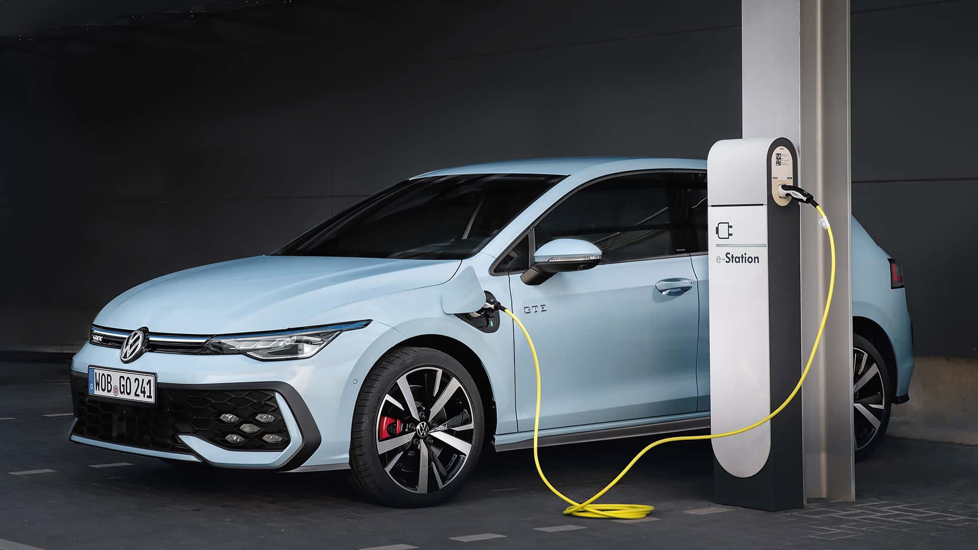 Volkswagen Golf GTE plugged into an EV charging station, highlighting its plug-in hybrid technology