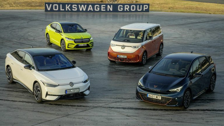 Volkswagen Group showcases four electric vehicles on a test track beneath its corporate sign