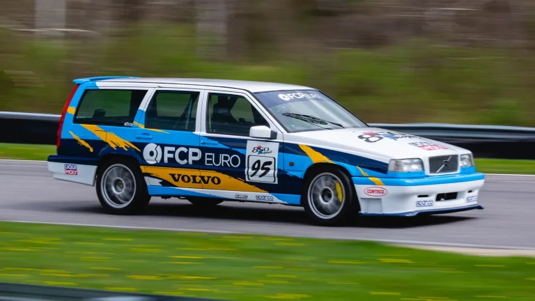 A Volvo 850 is cruising on a straight road