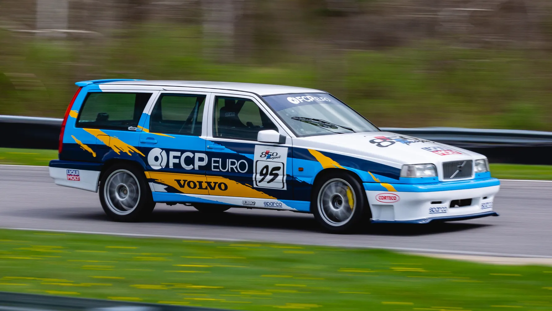 A Volvo 850 is cruising on a straight road