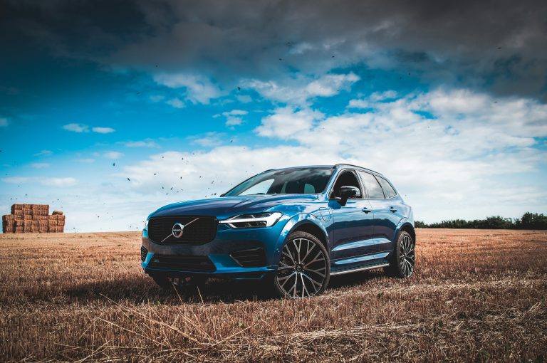 A Volvo is standing on a grassland with brown weeds