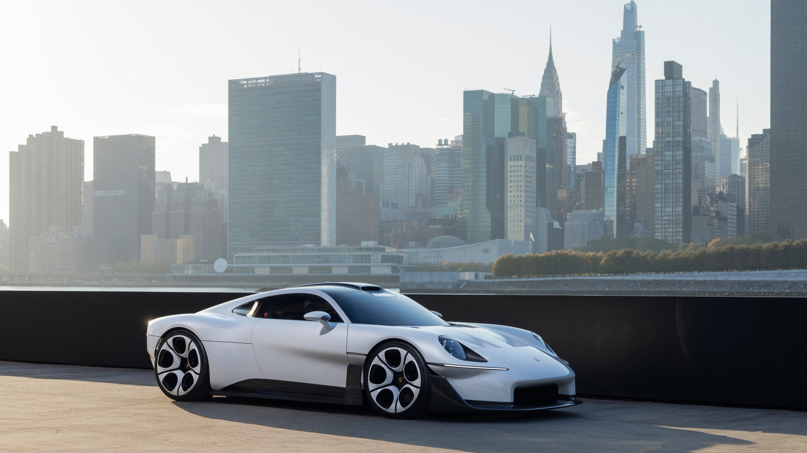 White Porsche Mission S concept sports car parked against a modern city skyline