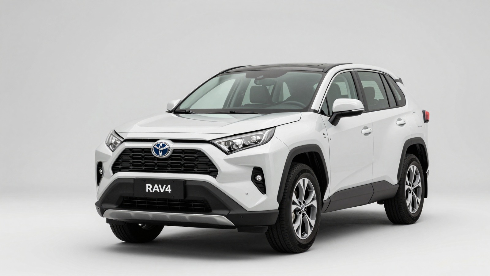 White Toyota RAV4 displayed against a clean studio background, highlighting its rugged styling and compact SUV design