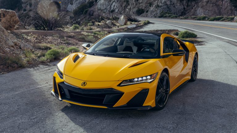 Yellow Acura NSX Type S parked on a mountain road, highlighting its aggressive supercar design