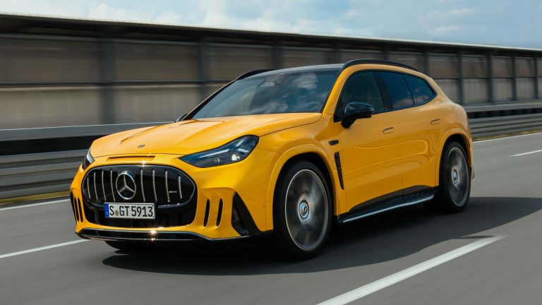 Yellow Mercedes-AMG GT SUV speeding along a highway, showcasing its aggressive grille and sporty luxury design