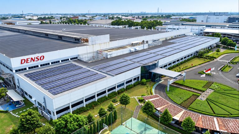 Aerial view of Denso’s industrial facility featuring extensive rooftop solar panels and landscaped grounds
