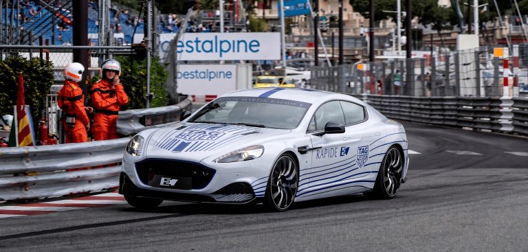 Aston Martin Rapide E electric sedan racing through a street circuit