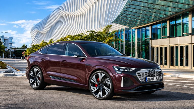 Audi Q8 e-tron parked outside a modern architectural complex in an urban setting