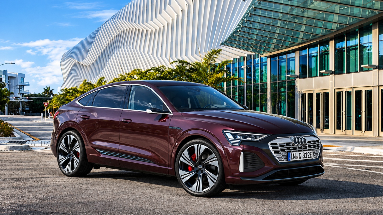 Audi Q8 e-tron parked outside a modern architectural complex in an urban setting