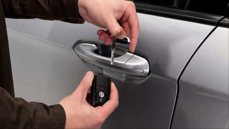 Car door handle shown with a key being used for manual access