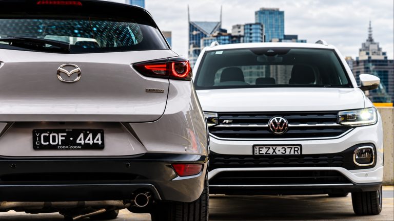 Rear view of silver SUV beside front view of white car