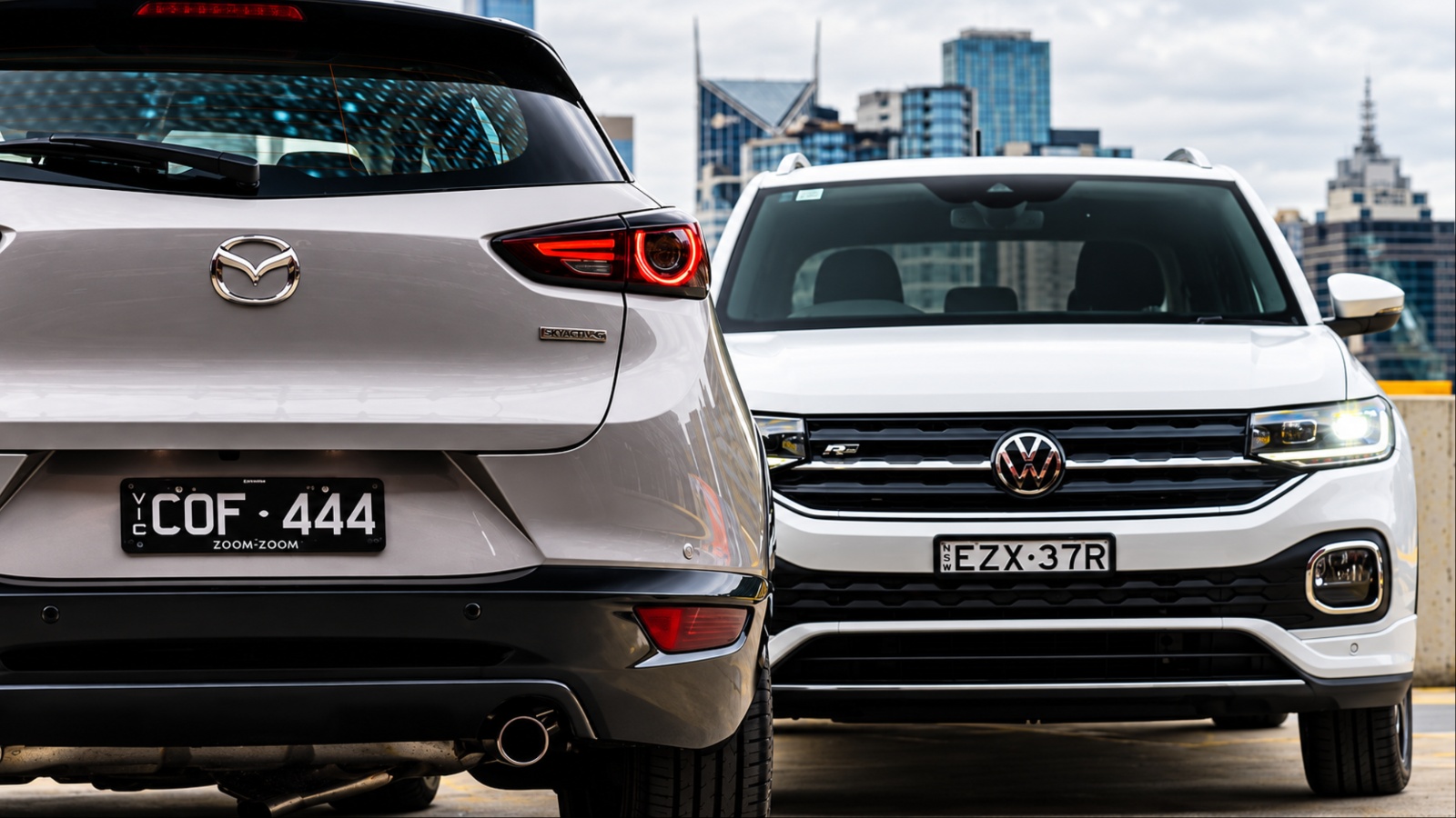 Rear view of silver SUV beside front view of white car