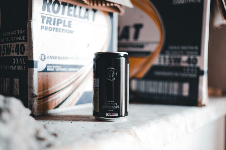 An oil filter is kept on the table near the battery