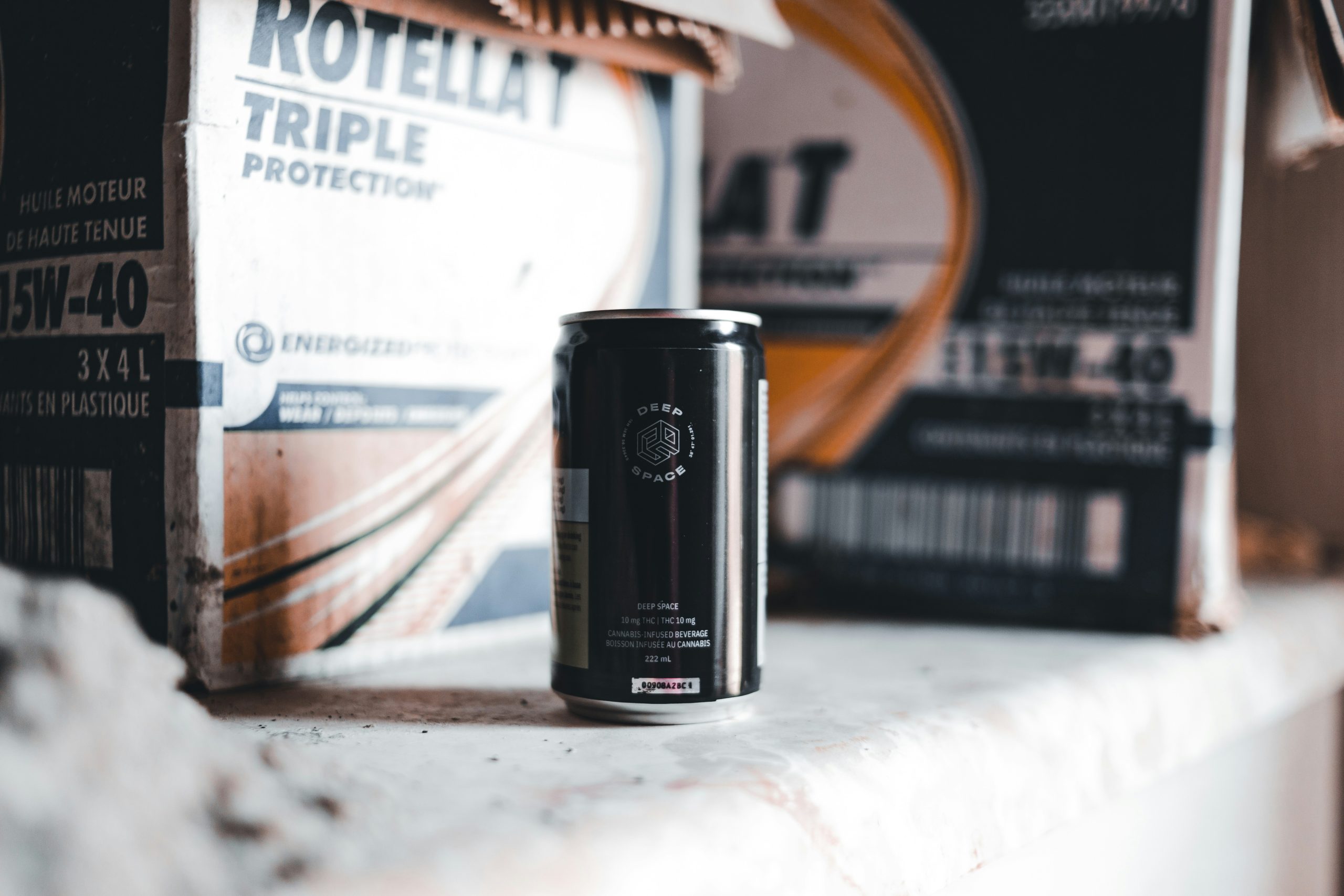 An oil filter is kept on the table near the battery