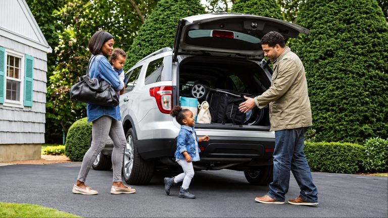 Family loading luggage into SUV