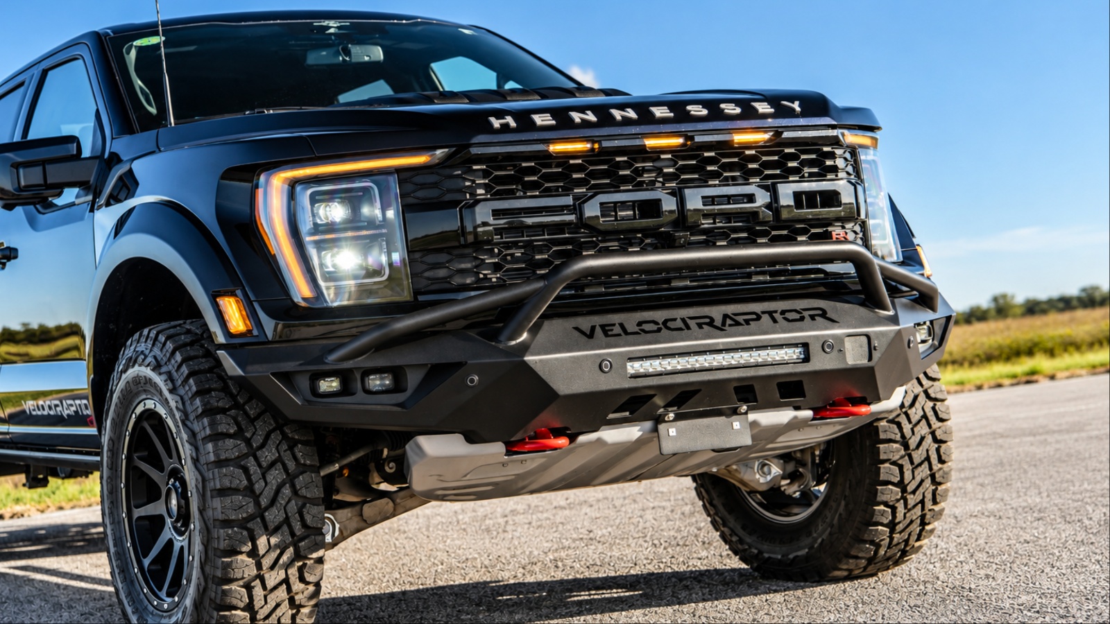 A Hennessey VelociRaptor is cruising on a concrete road